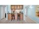 Inviting kitchen with light wood cabinets, granite countertops, and barstool seating at 6279 Sun Blvd # 103, St Petersburg, FL 33715
