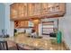 Kitchen bar with granite countertops, a stainless steel sink, and wooden cabinetry at 6279 Sun Blvd # 103, St Petersburg, FL 33715