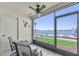 Relaxing screened lanai with a ceiling fan, offering views of the water and a nearby bridge at 6279 Sun Blvd # 103, St Petersburg, FL 33715