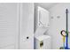 Convenient laundry closet with a stacked washer and dryer unit and storage at 6279 Sun Blvd # 103, St Petersburg, FL 33715