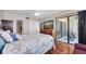 Serene main bedroom featuring hardwood floors, sliding door access to a balcony, and an ensuite bathroom at 6279 Sun Blvd # 103, St Petersburg, FL 33715