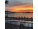 Community pool with lounge chairs overlooking the bay and bridge during sunset at 6279 Sun Blvd # 103, St Petersburg, FL 33715
