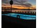 Community pool overlooking the bay and bridge at sunset, featuring seating at 6279 Sun Blvd # 103, St Petersburg, FL 33715