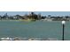 Beautiful water view with a passing boat, blue skies, and plenty of outdoor seating at 6279 Sun Blvd # 103, St Petersburg, FL 33715