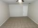 This bedroom features tile flooring and neutral walls, complemented by a white door at 6411 26Th W St, Bradenton, FL 34207