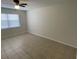 This bedroom features tile flooring and a ceiling fan with light, and a window at 6411 26Th W St, Bradenton, FL 34207