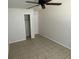 This bedroom features tile flooring with a closet and white door at 6411 26Th W St, Bradenton, FL 34207