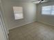This bedroom features tile flooring and a dual window for natural light and ceiling fan at 6411 26Th W St, Bradenton, FL 34207