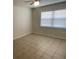 This bedroom features tile flooring and a large window for natural light at 6411 26Th W St, Bradenton, FL 34207