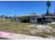 Single story home featuring a screen lanai and drought tolerant landscaping at 6411 26Th W St, Bradenton, FL 34207