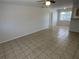 Spacious living room with tile flooring that opens to kitchen and hallway at 6411 26Th W St, Bradenton, FL 34207