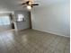 Open-concept living room with tile flooring and open to the kitchen with a bar at 6411 26Th W St, Bradenton, FL 34207
