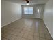 Bright living room with tile flooring, a ceiling fan, and natural light from the window at 6411 26Th W St, Bradenton, FL 34207
