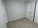 Neutral room showcasing tile flooring, baseboards, and an electrical outlet at 6411 26Th W St, Bradenton, FL 34207