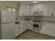Modern kitchen featuring stainless steel appliances and bright white cabinetry at 6646 Del Prado Ter, New Port Richey, FL 34652