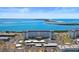 Stunning aerial view of a waterfront condo with beautiful blue water and sandy beach in the background at 7 Elgin Pl # 510, Dunedin, FL 34698