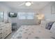 Relaxing bedroom with coastal decor, ceiling fan, and bright window at 7 Elgin Pl # 510, Dunedin, FL 34698