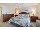 Bedroom featuring a wood-framed bed and floral bedding at 7 Elgin Pl # 510, Dunedin, FL 34698