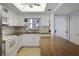 Well-lit kitchen featuring white cabinets, granite countertops, and modern appliances for easy meal preparation at 7 Elgin Pl # 510, Dunedin, FL 34698