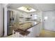 Bright kitchen featuring stainless steel appliances, granite countertops, and a stylish island with seating at 7 Elgin Pl # 510, Dunedin, FL 34698