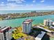 Stunning aerial view of the condo building with bay views and amenities at 736 Island Way # 1101, Clearwater Beach, FL 33767