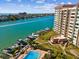 Aerial view of condo building with pool, boat docks, and Intracoastal waterway at 736 Island Way # 1101, Clearwater Beach, FL 33767