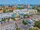 Aerial view of a Publix grocery store, surrounded by palm trees and parking lots, with a water view in the distance at 736 Island Way # 1101, Clearwater Beach, FL 33767