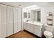 Bathroom with a single sink vanity, large mirror, and bright white fixtures at 736 Island Way # 1101, Clearwater Beach, FL 33767