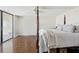 Bedroom with hardwood floors, a four-post bed, and a sliding glass door to a balcony at 736 Island Way # 1101, Clearwater Beach, FL 33767