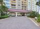 Elegant condo entrance with porte cochere and lush landscaping at 736 Island Way # 1101, Clearwater Beach, FL 33767