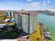 Luxury building with a water view featuring balconies and meticulously manicured landscaping at 736 Island Way # 1101, Clearwater Beach, FL 33767