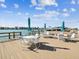 Relaxing dockside patio with tables, chairs, and waterfront views at 736 Island Way # 1101, Clearwater Beach, FL 33767