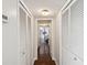 Hallway view featuring multiple white closet doors with view to bedroom in the background at 736 Island Way # 1101, Clearwater Beach, FL 33767
