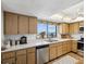 Bright kitchen featuring stainless steel appliances, wood cabinets and a window overlooking the waterfront at 736 Island Way # 1101, Clearwater Beach, FL 33767