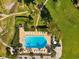 Aerial view of a community swimming pool with surrounding patio, furniture, and manicured landscaping at 736 Island Way # 1101, Clearwater Beach, FL 33767
