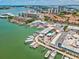 Aerial view featuring boat docks, parking, and waterfront commercial buildings along the Clearwater waterfront at 736 Island Way # 1101, Clearwater Beach, FL 33767