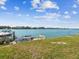 Waterfront view featuring boat dock with watercraft, seawall and lush lawn at 736 Island Way # 1101, Clearwater Beach, FL 33767