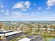 Expansive view showcasing the neighborhood on the water, parking spots, and tennis courts at 736 Island Way # 1101, Clearwater Beach, FL 33767
