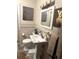 Cozy bathroom featuring a pedestal sink, toilet, and stylish decorative wall art at 7435 46Th N Ave, St Petersburg, FL 33709