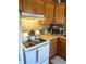 Cozy kitchen features wooden cabinetry, modern appliances, and tile backsplash at 7435 46Th N Ave, St Petersburg, FL 33709