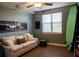 Relaxing bedroom with a comfortable couch, coastal-themed artwork, and a surf board at 750 4Th S Ave # 403C, St Petersburg, FL 33701
