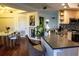 Open kitchen with island bar and stainless sink adjacent dining area at 750 4Th S Ave # 403C, St Petersburg, FL 33701