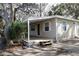 Side view of home featuring a covered porch, white trim, and neutral siding at 7932 Palatine Dr, Hudson, FL 34667