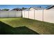 Well-maintained backyard with lush green grass and a privacy fence for outdoor enjoyment at 811 College Leaf Way, Ruskin, FL 33570