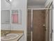 Tiled bathroom featuring shower with glass door, sink with mirror, and a neutral color scheme at 811 College Leaf Way, Ruskin, FL 33570