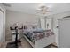 Cozy bedroom featuring a queen-sized bed, ceiling fan, and neutral decor for a comfortable and relaxing space at 811 College Leaf Way, Ruskin, FL 33570