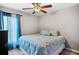 Bedroom with light blue bedding, sheer curtains, and ceiling fan for a comfortable space at 811 College Leaf Way, Ruskin, FL 33570