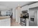 Well-equipped kitchen with stainless steel appliances, white cabinets, and convenient access to the living areas at 811 College Leaf Way, Ruskin, FL 33570
