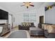Comfortable living room with stylish gray sofas, patterned rug, and coastal-themed artwork, perfect for relaxation at 811 College Leaf Way, Ruskin, FL 33570