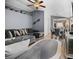Spacious living room with gray sectional sofa, vaulted ceilings, and an open layout leading to the dining area at 811 College Leaf Way, Ruskin, FL 33570